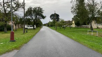 a road with a white van parked on the side at Domek na statku in Klipec