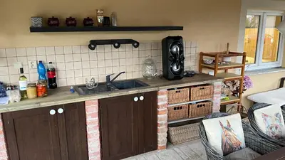 a kitchen with a sink and a counter at Domek na statku in Klipec