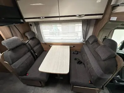 a table in the back of an rv with seats at Hotel na kolech in Kladno