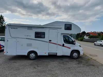 a white rv parked in a parking lot at Hotel na kolech in Kladno
