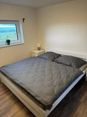 a bed in a bedroom with a window at Apartmán 2 Jägerhaus in Libochovice