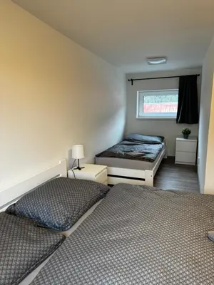 a bedroom with two beds and a window at Apartmán 2 Jägerhaus in Libochovice
