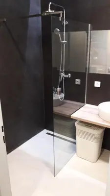 a bathroom with a glass shower with a sink at Hotel & Hostel Letov in Prague