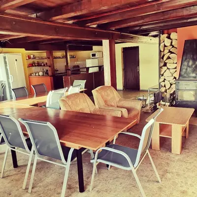 a dining room with a wooden table and chairs at Centrální chata Kanoistika Roudnice in Vědomice