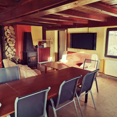a living room with a table and a fireplace at Centrální chata Kanoistika Roudnice in Vědomice