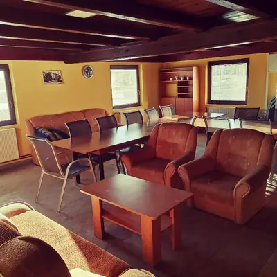 a waiting room with leather chairs and tables and a waiting room at Centrální chata Kanoistika Roudnice in Vědomice