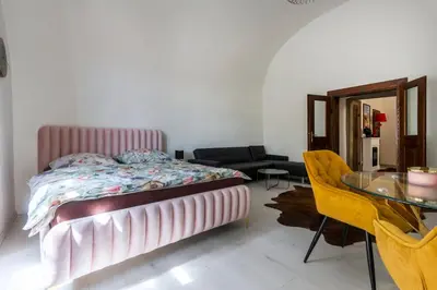 a bedroom with a bed and a glass table at Apartmán Hradčany 7 in Prague