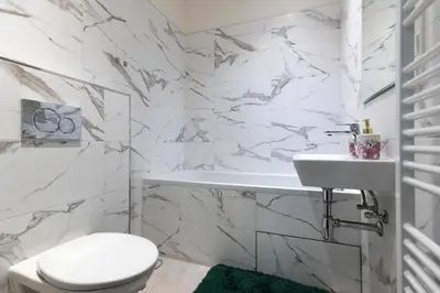 a white bathroom with a toilet and a sink at Apartmán Hradčany 7 in Prague