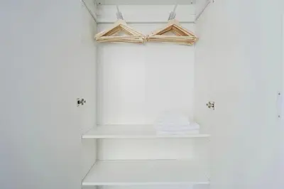 a shelf in a bathroom with two wooden hangers at Blueground Rostovska str nr park foodie area PRG-28 in Prague