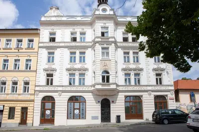 a large white building on a city street at Blueground Rostovska str nr park foodie area PRG-28 in Prague