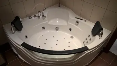 a large white bath tub in a bathroom at The Old town's apartment in Prague