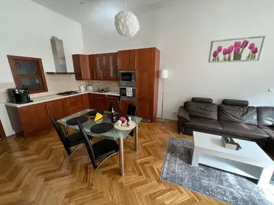a living room with a table and a couch at The Old town's apartment in Prague