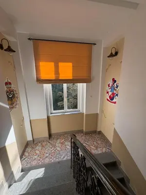 a stairway with a painting on the wall and a staircase sidx sidx at Arbes 14 - Mirror of Prague in Prague