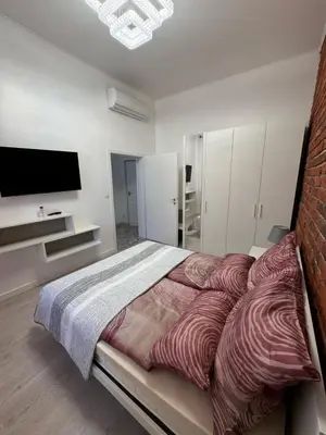 a bedroom with a large bed and a flat screen tv at Arbes 14 - Mirror of Prague in Prague