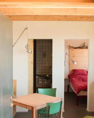 a room with a table and a bed at Veritas Beyond Glamping in Hošťka