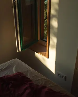 a window in a room with a bed in front of it at Veritas Beyond Glamping in Hošťka