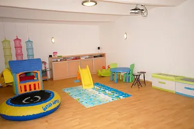 a room with a play room with play equipment at Příjemné místo pro odpočinek s bazeném in Radovesice