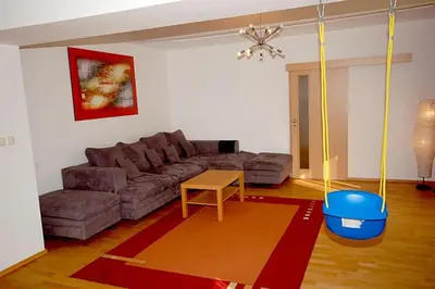 a living room with a couch and a table at Příjemné místo pro odpočinek s bazeném in Radovesice
