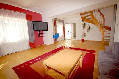 a living room with a couch and a table at Příjemné místo pro odpočinek s bazeném in Radovesice