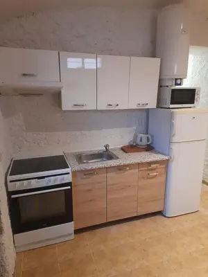 a kitchen with white cabinets and a sink at Ubytování Ždírec - Apartmán 3 in Doksy
