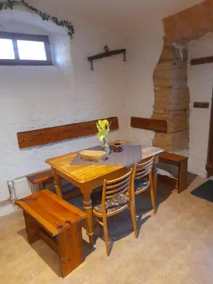 a wooden table with a vase of flowers on it at Ubytování Ždírec - Apartmán 3 in Doksy