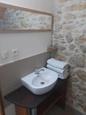 a bathroom with a sink and a mirror and towels at Ubytování Ždírec - Apartmán 3 in Doksy