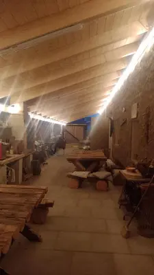a room with wooden tables in a building with lights at Ubytování Ždírec - Apartmán 3 in Doksy