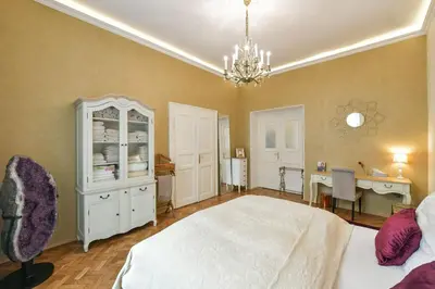 a bedroom with a bed and a desk in it at Amethyst apartment in Prague