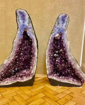 two halves of a purple fruit on a wooden floor at Amethyst apartment in Prague