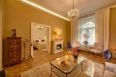 a living room with a table and a bedroom at Amethyst apartment in Prague