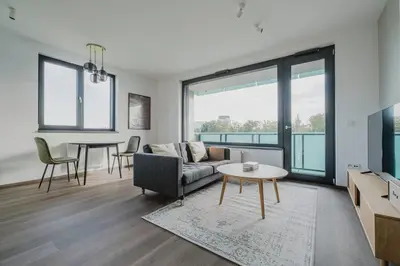 a living room with a couch and a table at Blueground Prague 3 new build balcony PRG-37 in Prague