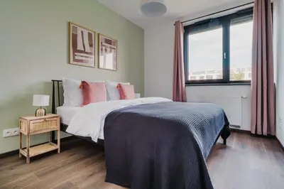 a bedroom with a bed and a window at Blueground Prague 3 new build balcony PRG-37 in Prague