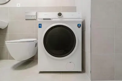 a washing machine in a bathroom next to a toilet at Blueground Prague 3 new build balcony PRG-37 in Prague