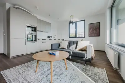 a living room with a couch and a table at Blueground Prague 3 new build balcony PRG-37 in Prague