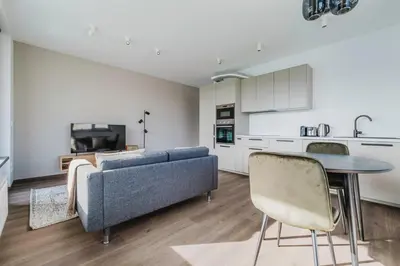 a living room with a couch and a table at Blueground Prague 3 new build balcony PRG-37 in Prague