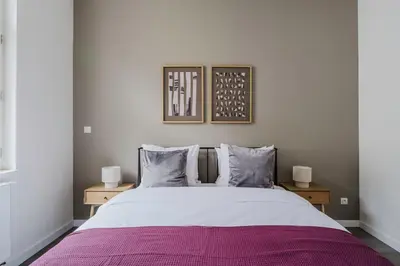 a bedroom with a large bed with a purple blanket at Blueground Žižkov renovated nr universities PRG-35 in Prague