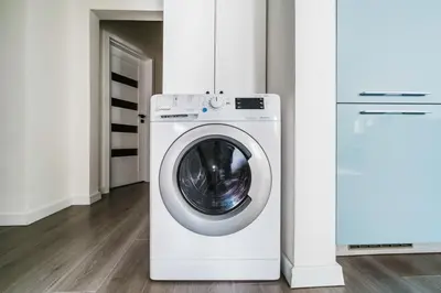 a washer and dryer in a white room at Blueground Žižkov renovated nr universities PRG-35 in Prague