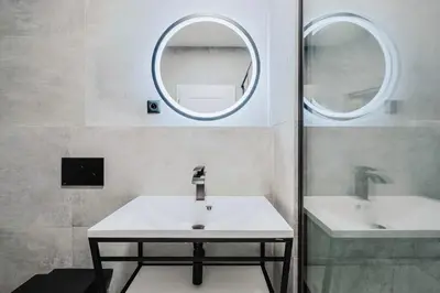a bathroom with two sinks and a mirror at Blueground Žižkov renovated nr universities PRG-35 in Prague