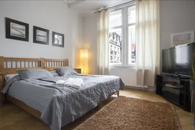 a bedroom with a bed and a flat screen tv at Apartment Dusni in Prague