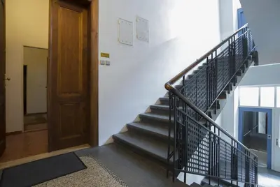 a staircase in a building with a wooden door at Apartment Dusni in Prague