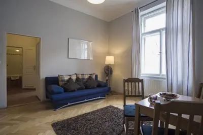a living room with a blue couch and a table at Apartment Dusni in Prague