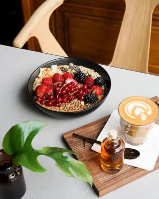 a bowl of fruit and a plate of food on a table at Apartment Dusni in Prague