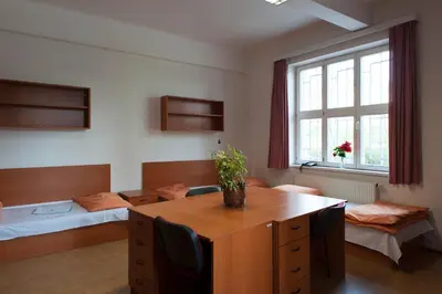 a room with a desk and a room with a bed at Roosevelt Hostel in Prague