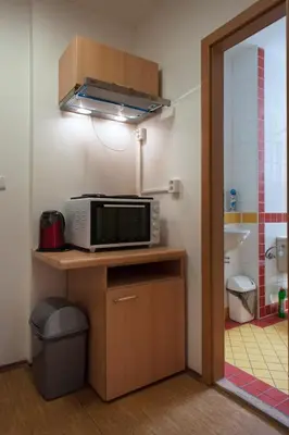 a microwave sitting on top of a counter in a kitchen at Roosevelt Hostel in Prague
