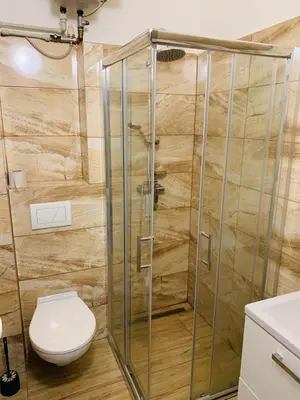 a shower stall in a bathroom with a toilet at Penzion Eška s Pivovarem MJ in Jince