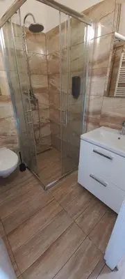 a bathroom with a shower and a toilet and a sink at Penzion Eška s Pivovarem MJ in Jince