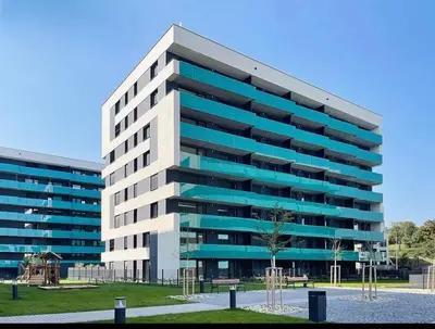 a large office building with blue windows at Stylish Modern Studio, Large Balcony, Prague 3 in Prague
