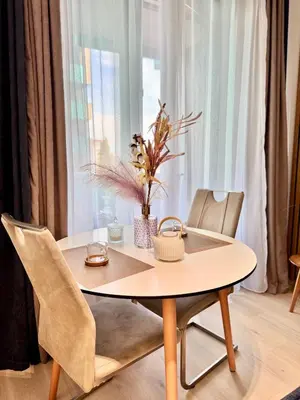 a dining room table with chairs and a table and a table and chairs at Stylish Modern Studio, Large Balcony, Prague 3 in Prague
