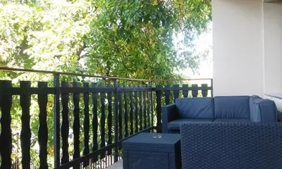 a blue chair and a table on a balcony at Apartmán Vrané in Vrané nad Vltavou