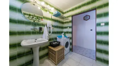 a bathroom with a sink and a washing machine at Apartmán Vrané in Vrané nad Vltavou